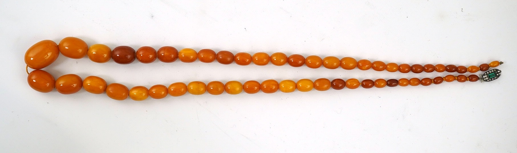 A single strand graduated oval amber bead necklace